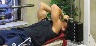 lying close-grip bar curl on high pulley